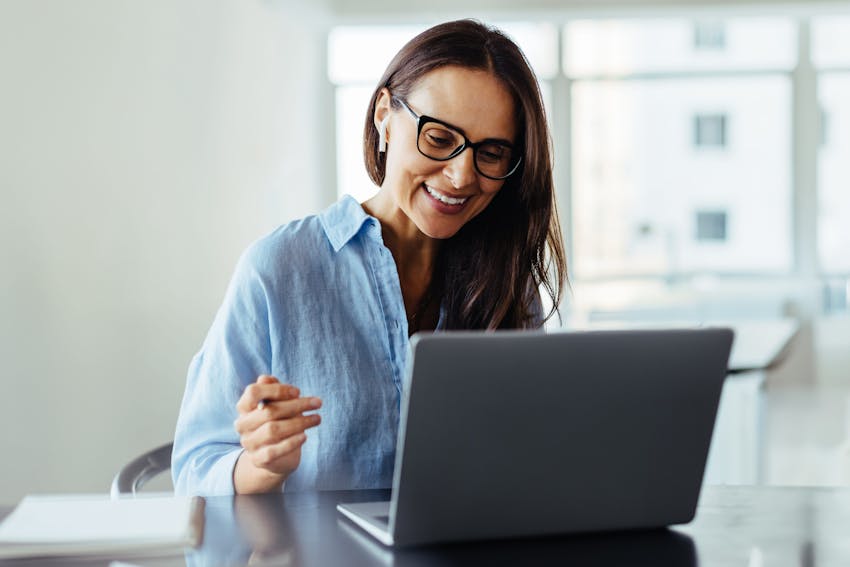 Smiling woman on her laptop