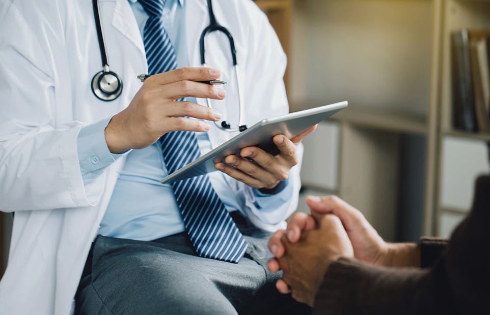 doctor looking at an ipad