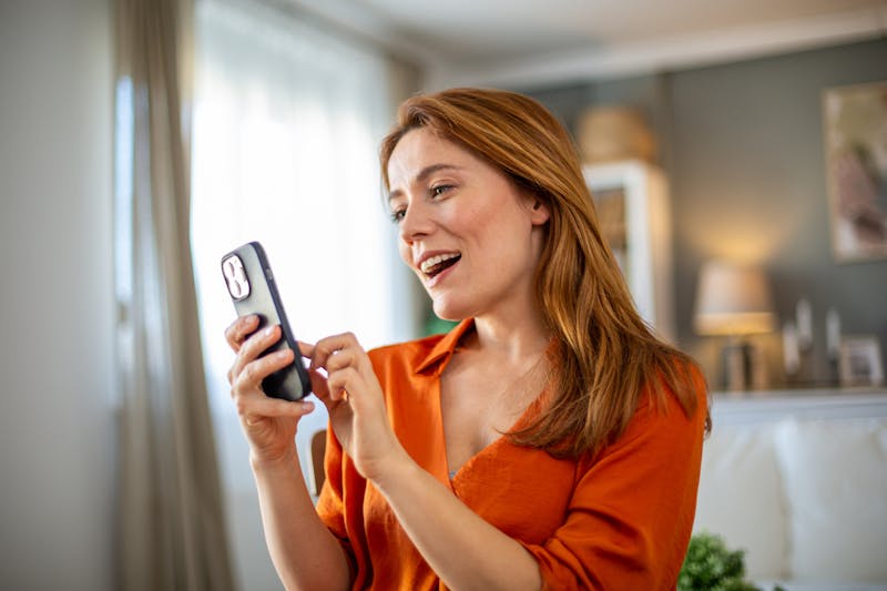 Woman smiling while on her phone