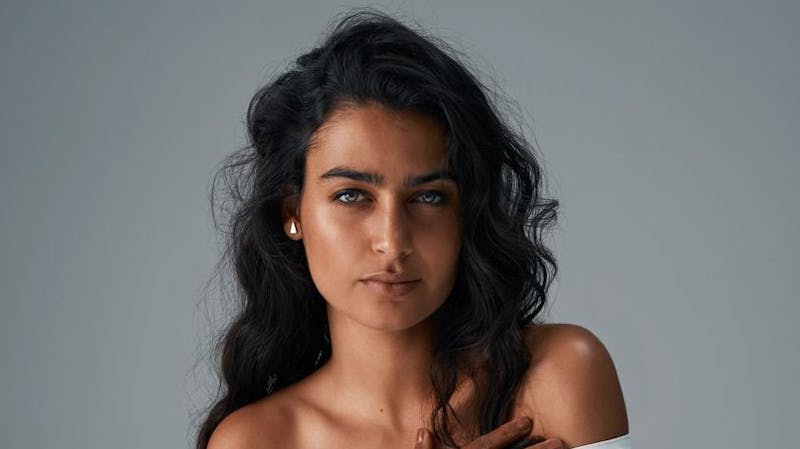 Beautiful woman looks at camera in studio shoot