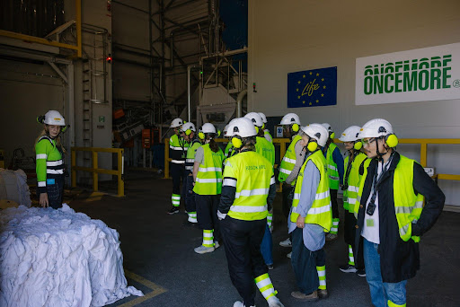 Tour goers view a bale of recycled materials