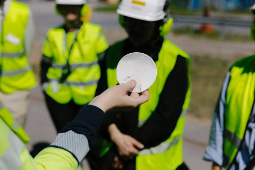 A visitors holds up a sample of a recycled material