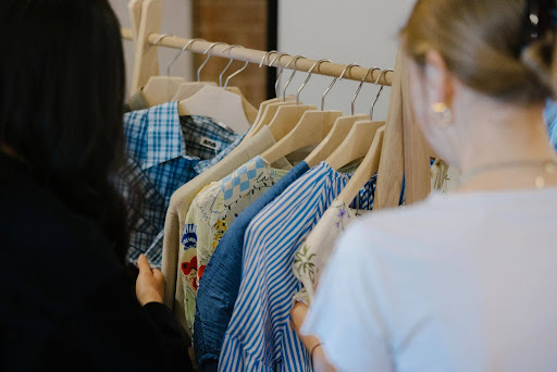 A viewer looks at fashion garments made of recycled next gen materials