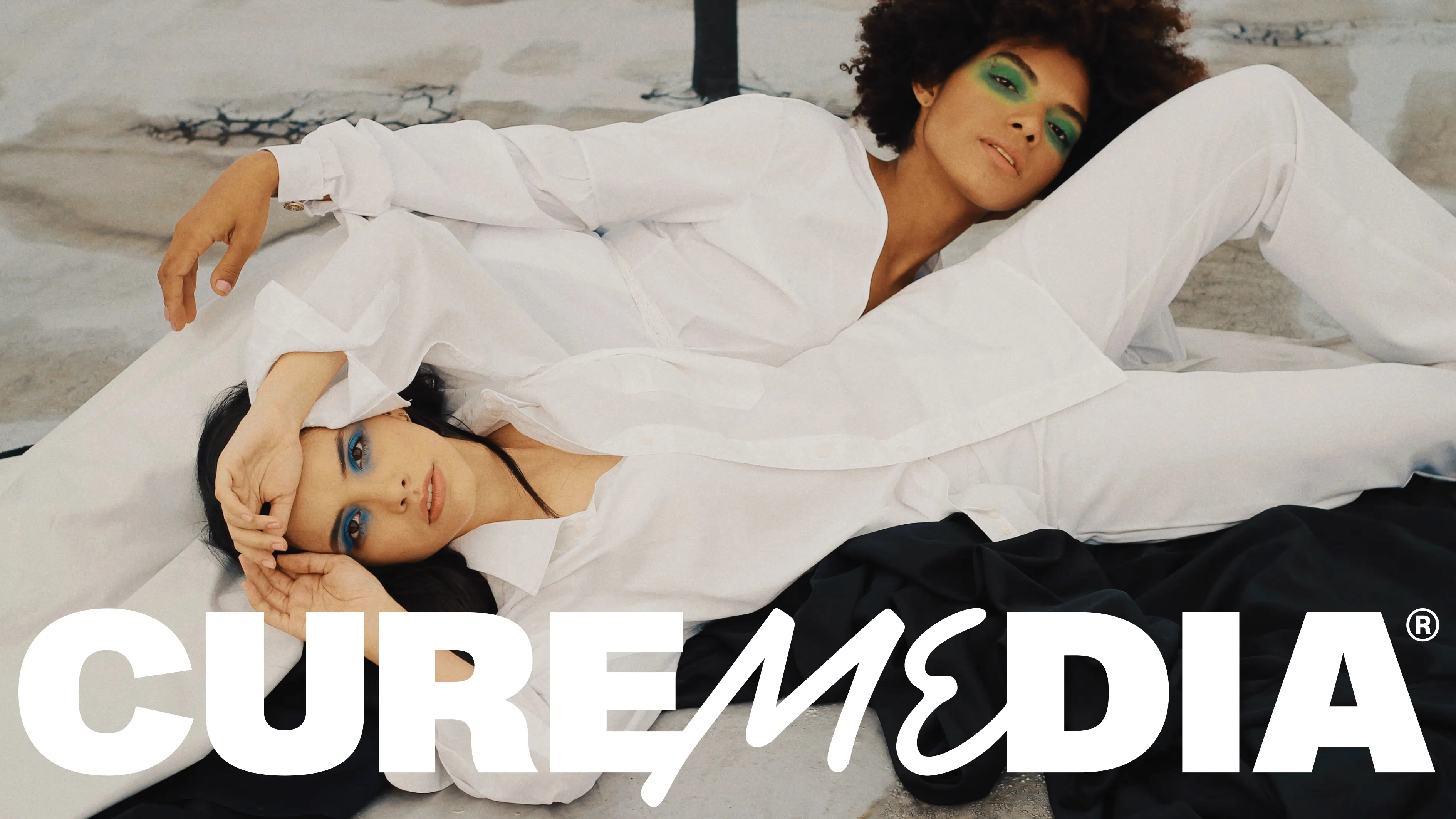 Strike the pose Two women dressed in white posing on a bed