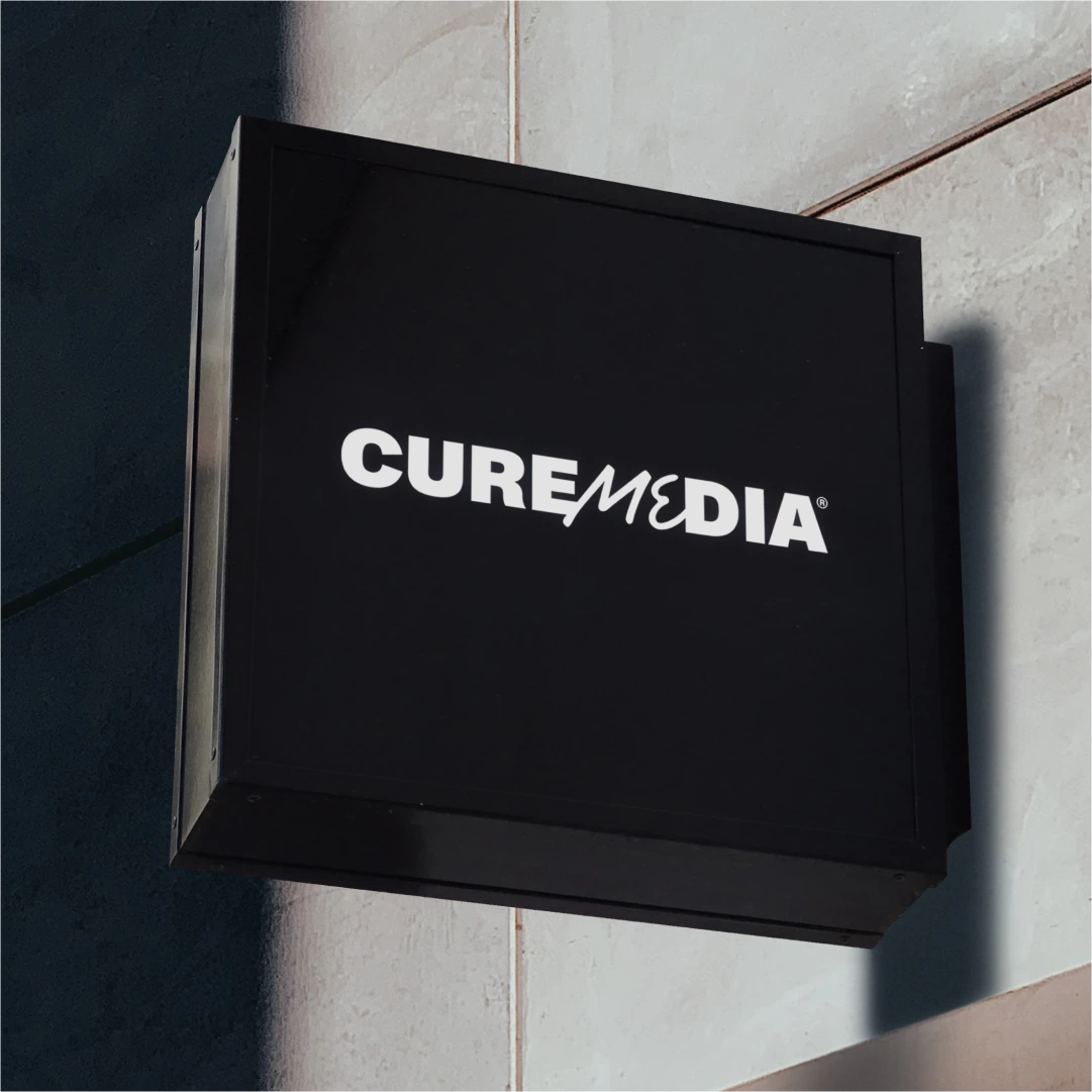 Cure Media sign on wall