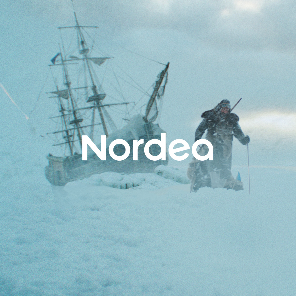 man skiing over ice with tall ship in the background