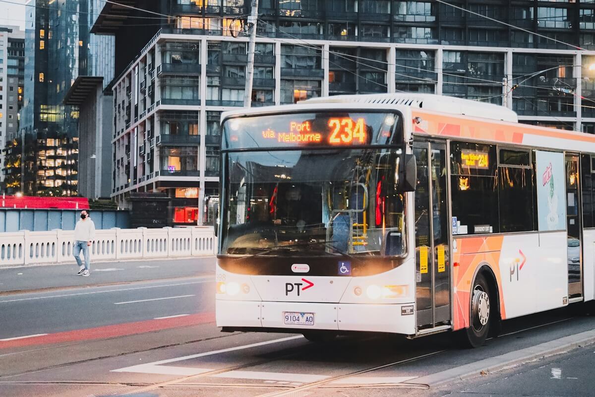 A picture of a bus in Melbourne at dusk.