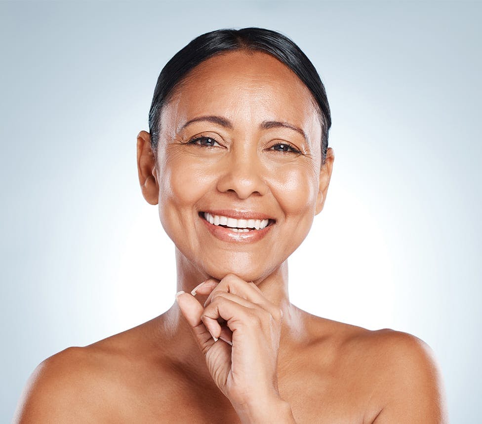 smiling woman touching her chin