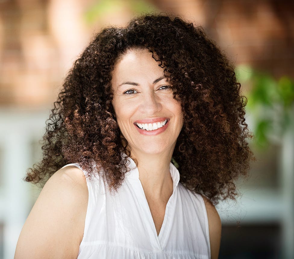 woman with afro hair smiling