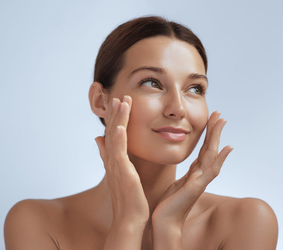 woman touching her cheeks