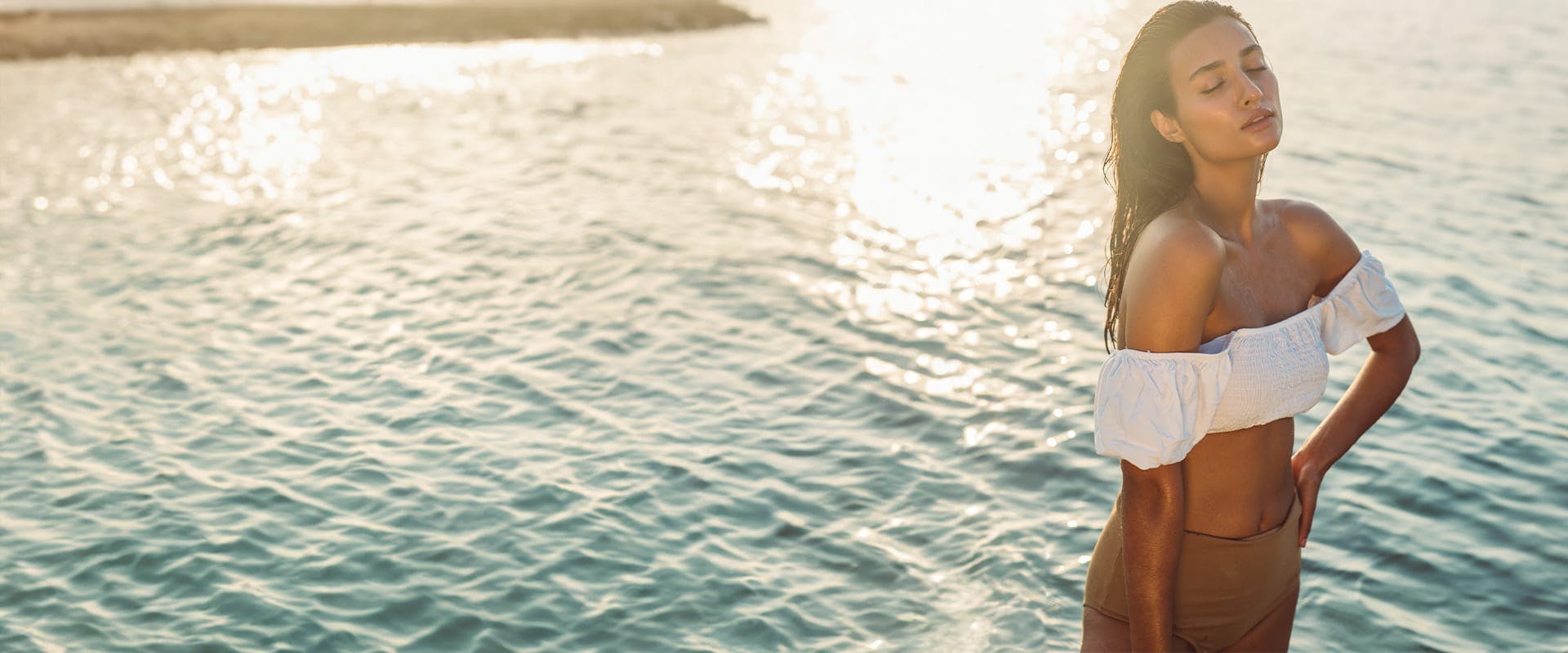 Woman standing by the ocean
