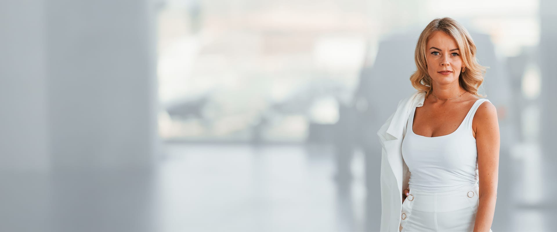 woman with blonde hair wearing all white