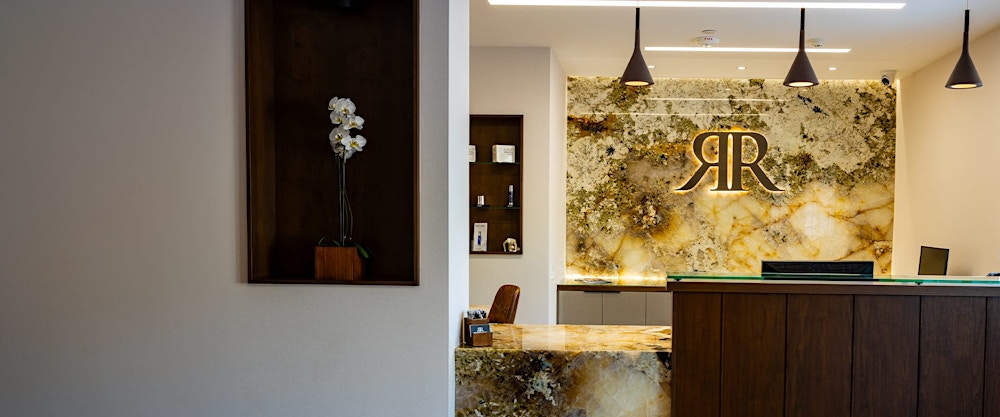 Dr. Rahban crossing his arms in front of the office