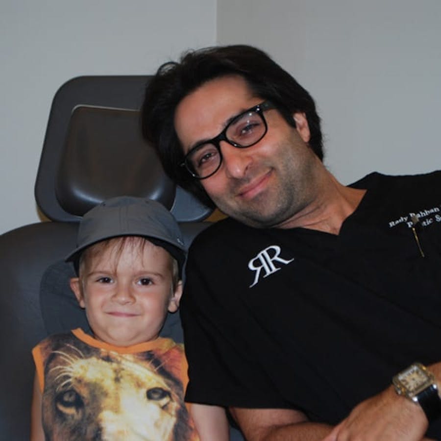 Dr. Rahban smiling with a pediatric patient