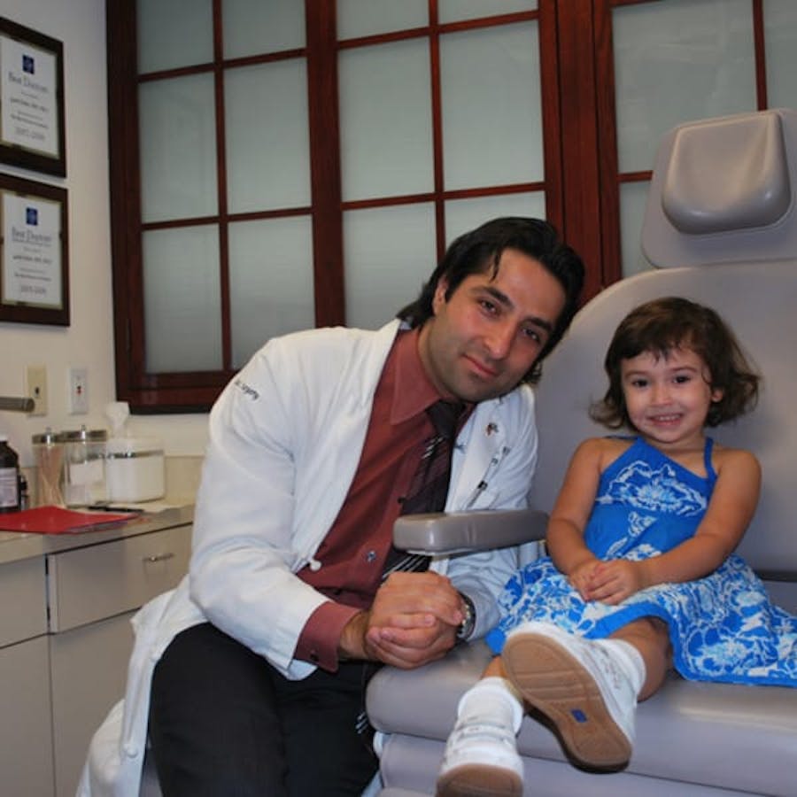 Dr. Rahban smiling with a pediatric patient