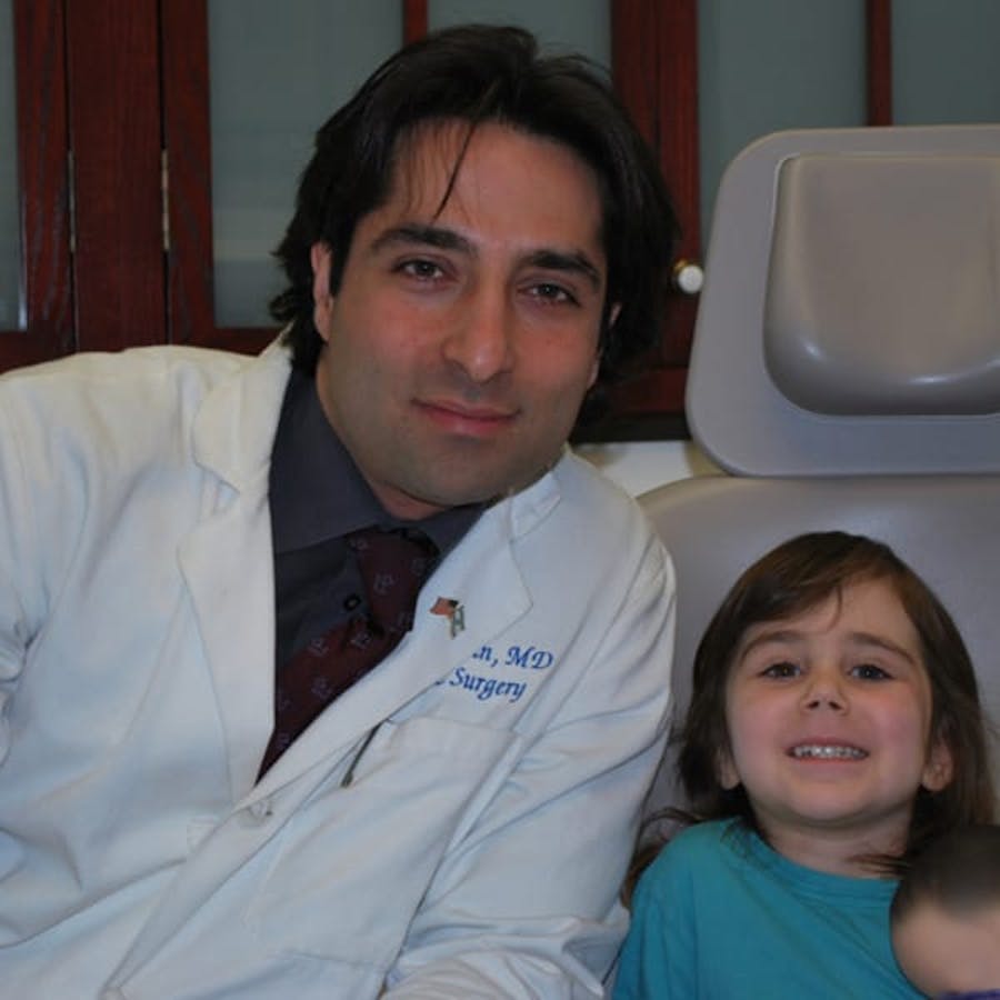 Dr. Rahban smiling with a pediatric patient