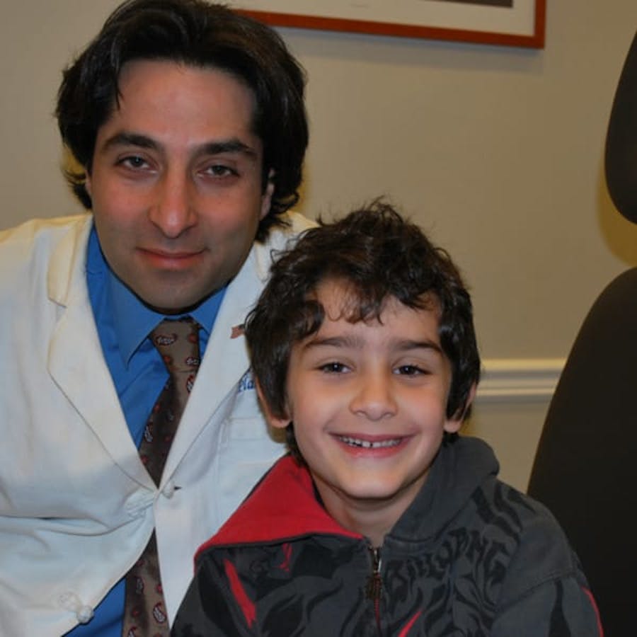 Dr. Rahban smiling with a pediatric patient