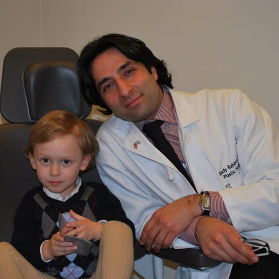 Dr. Rahban smiling with a pediatric patient