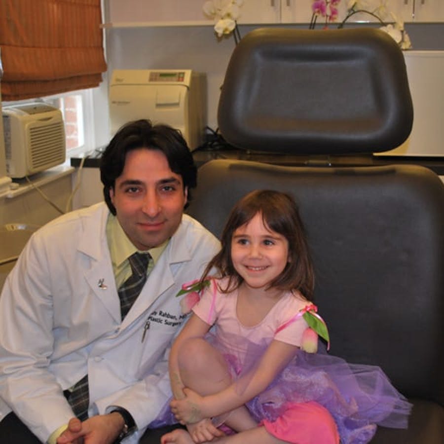 Dr. Rahban smiling with a pediatric patient