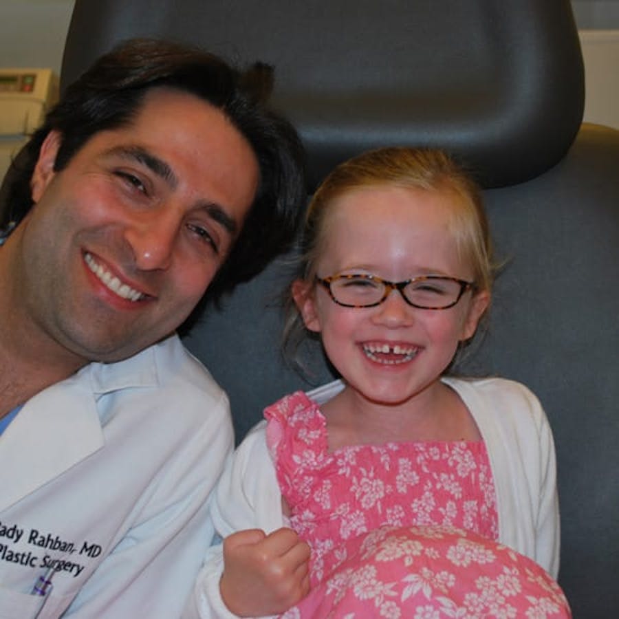 Dr. Rahban smiling with a pediatric patient