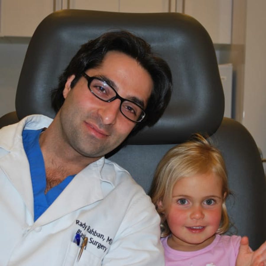 Dr. Rahban smiling with a pediatric patient