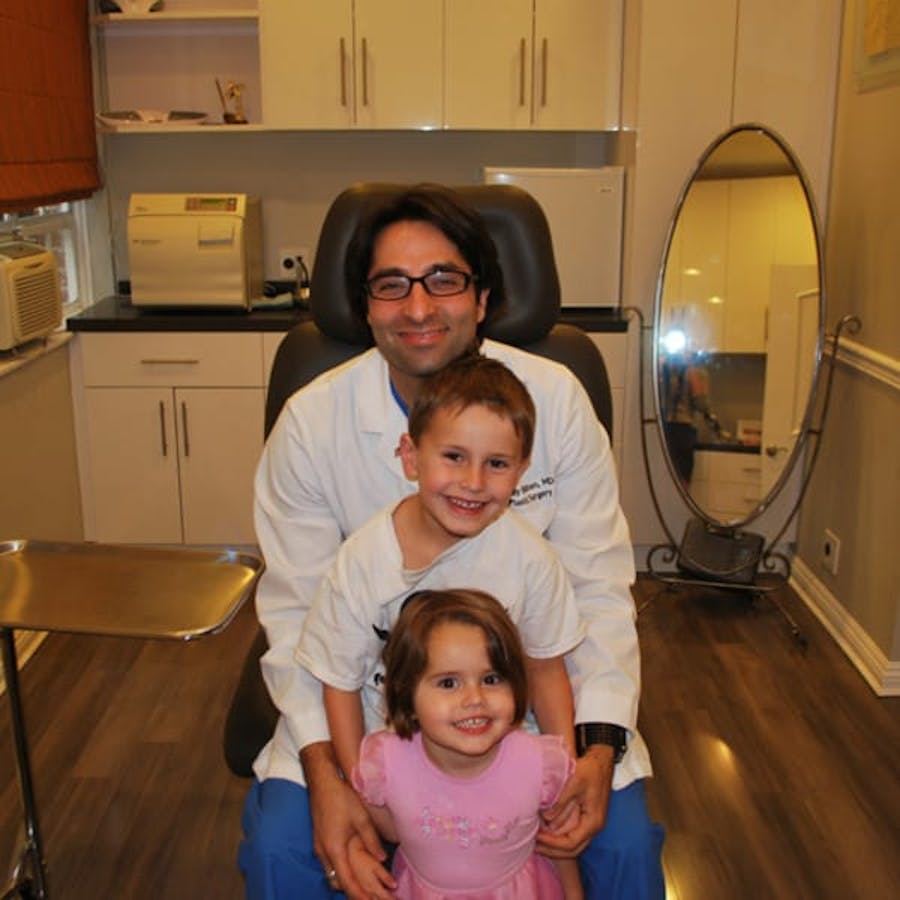 Dr. Rahban smiling with a pediatric patient