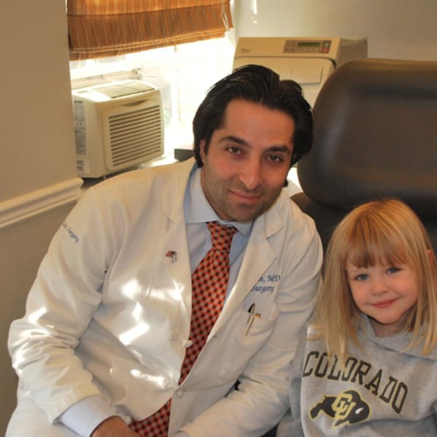 Dr. Rahban smiling with a pediatric patient