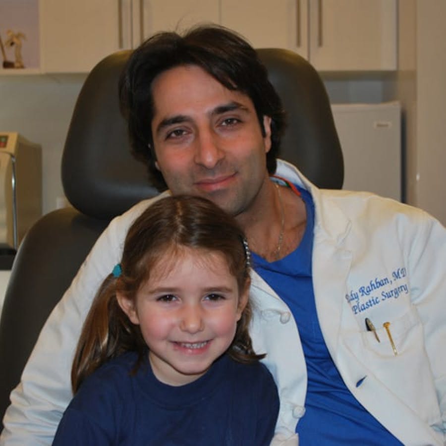 Dr. Rahban smiling with a pediatric patient