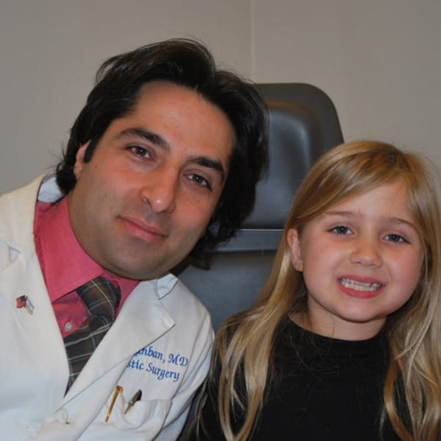 Dr. Rahban smiling with a pediatric patient