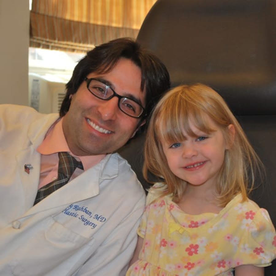 Dr. Rahban smiling with a pediatric patient