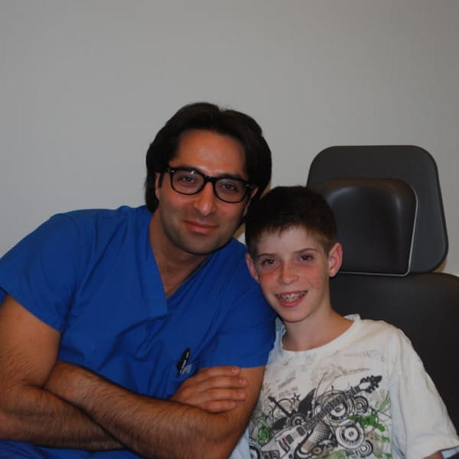 Dr. Rahban smiling with a pediatric patient