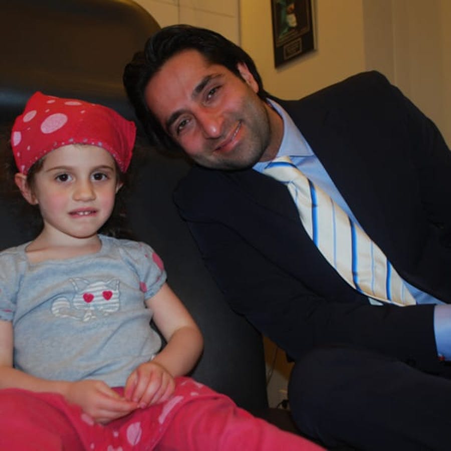 Dr. Rahban smiling with a pediatric patient