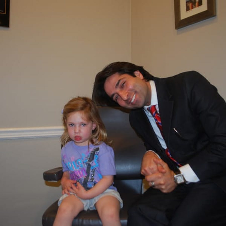 Dr. Rahban smiling with a pediatric patient