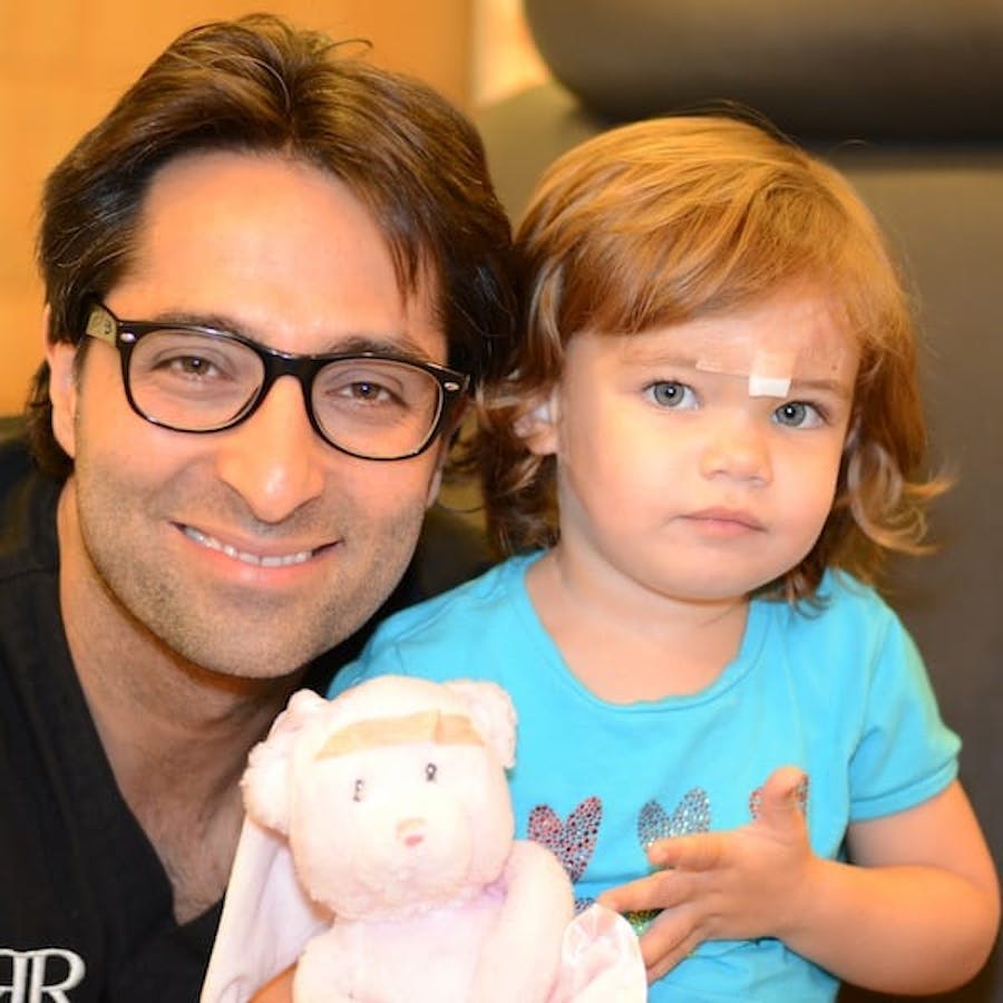 Dr. Rahban smiling with a pediatric patient