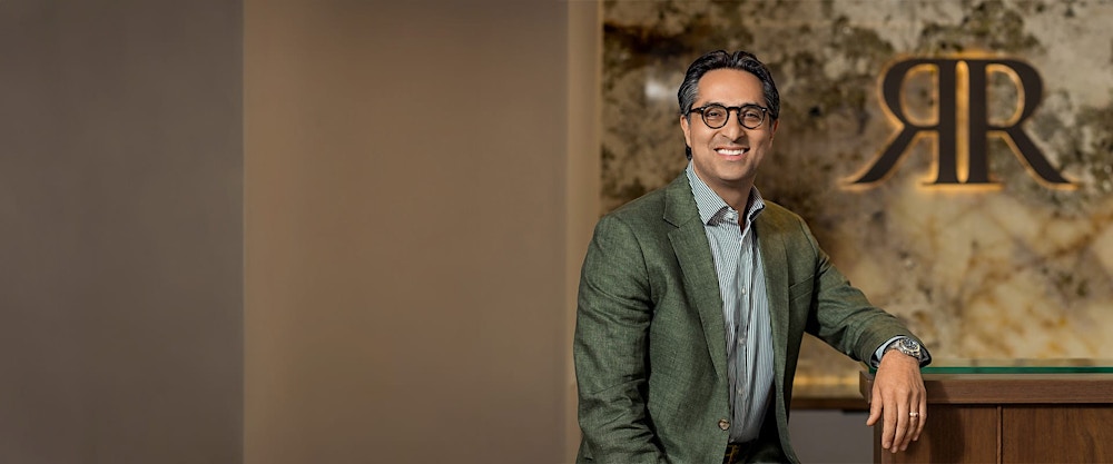 Dr. Rahban leaning against a counter