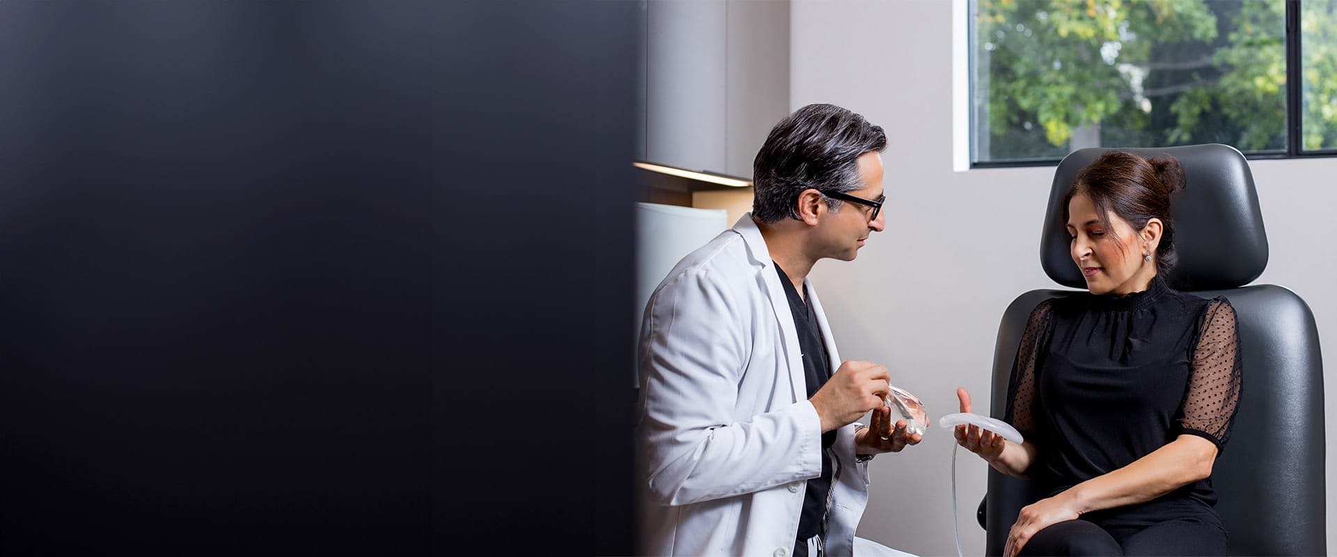 Dr. Rahban showing a patient silicone implants