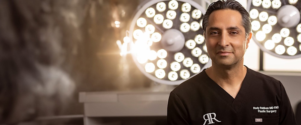 Dr. Rahban standing in front of surgical lights