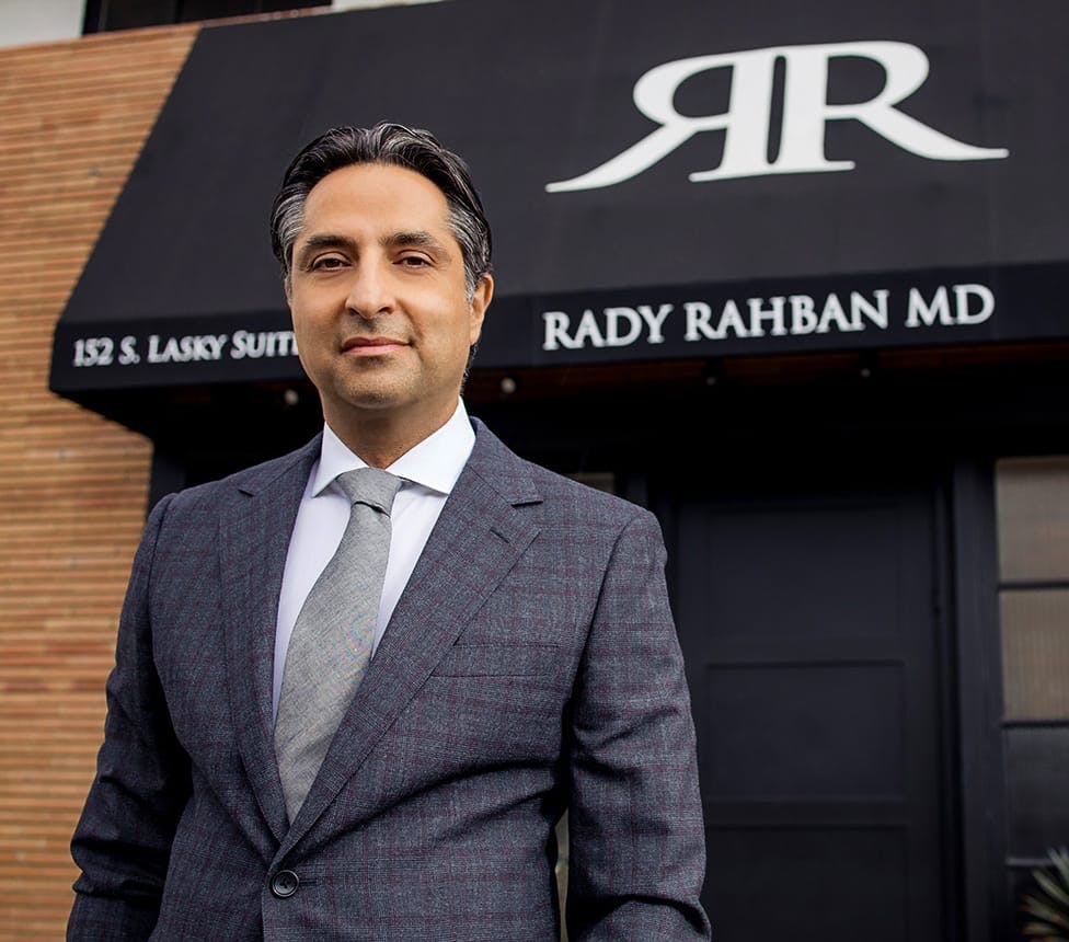 Dr. Rahban standing in front of his office