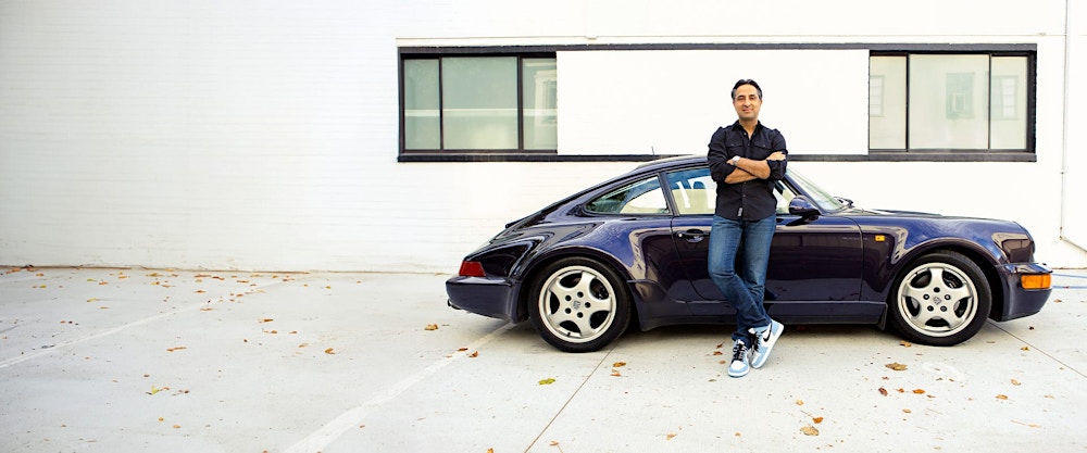 Dr. Rahban leaning against a car