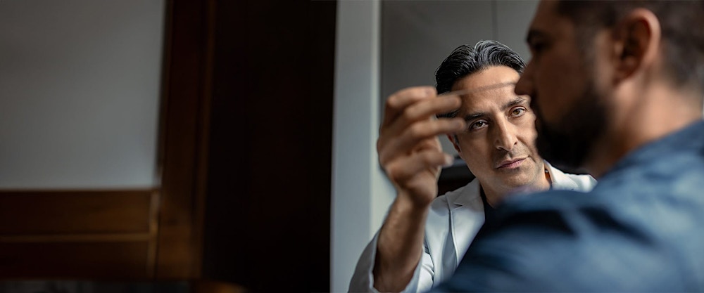 Dr. Rahban examining a patient's nose