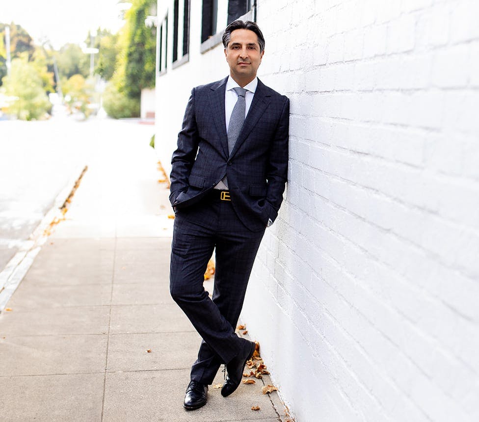 Dr. Rahban leaning against a wall