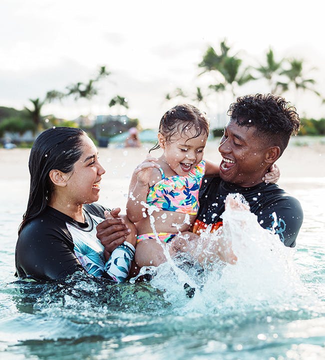 A young family splashing in the water