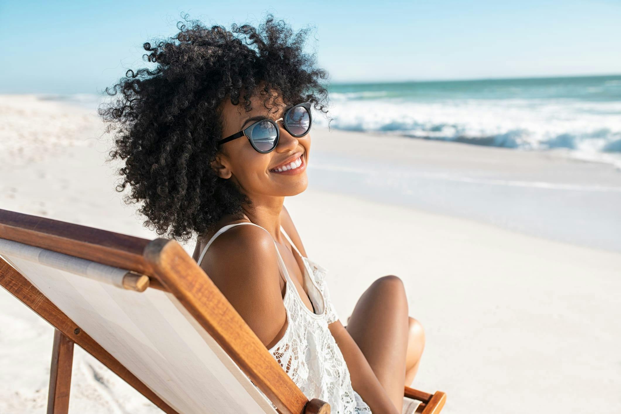 Woman with curly hair at the beach