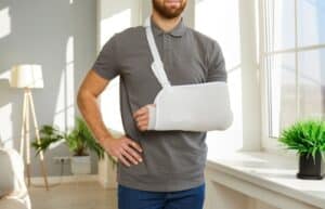 man have protective bandage on broken hand have rehabilitation after accident