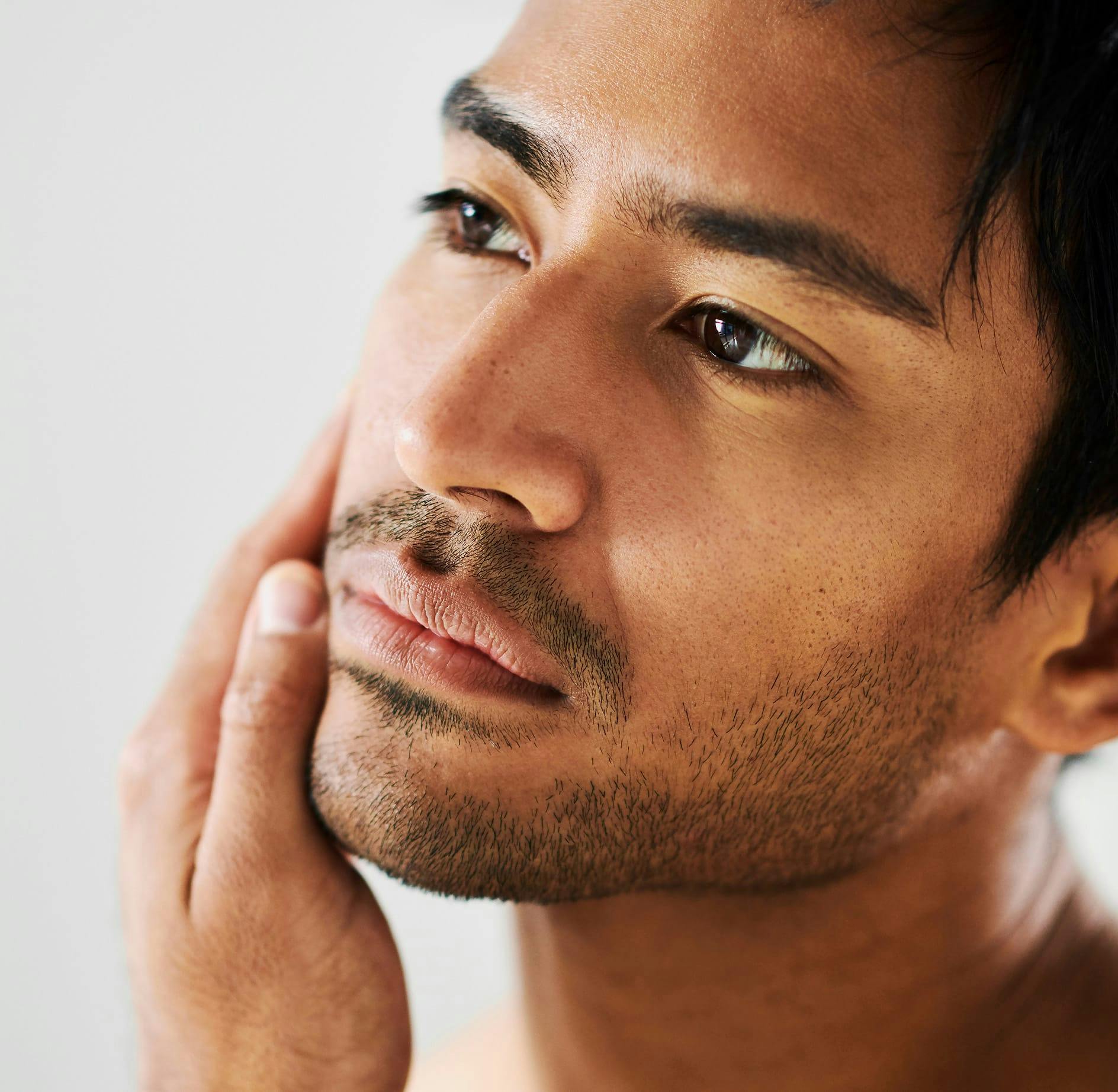 Man examining his beard