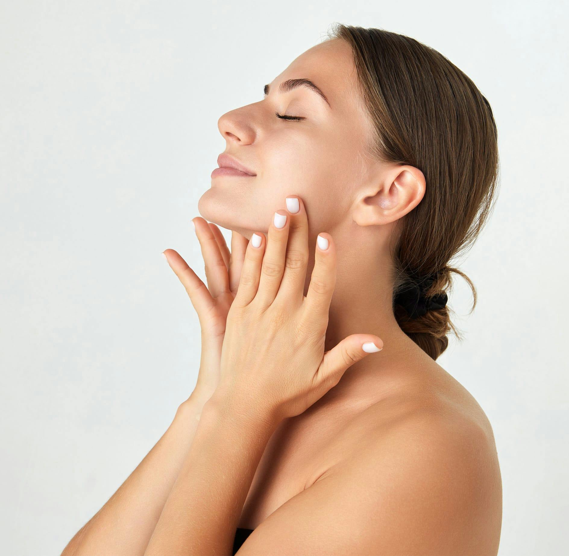 Woman smiling and touching cheeks