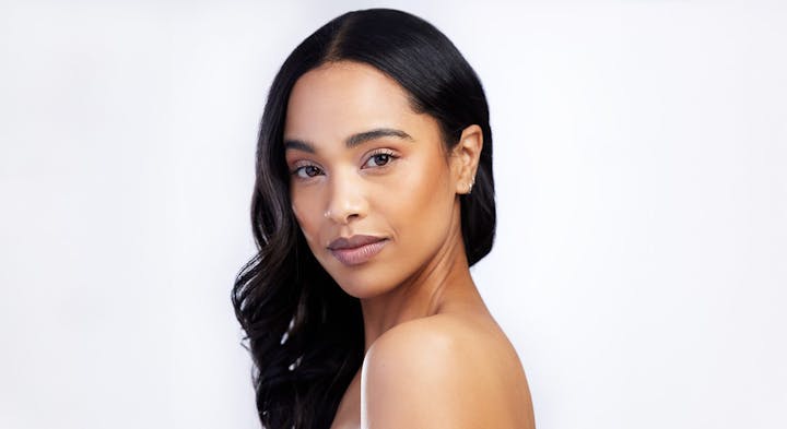 Woman smiling over shoulder