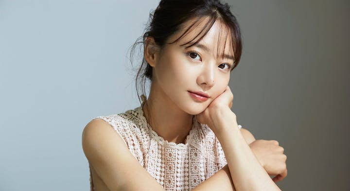 Young woman resting head on hand