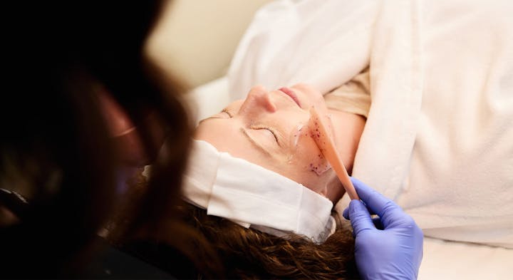 Woman receiving facial treatment