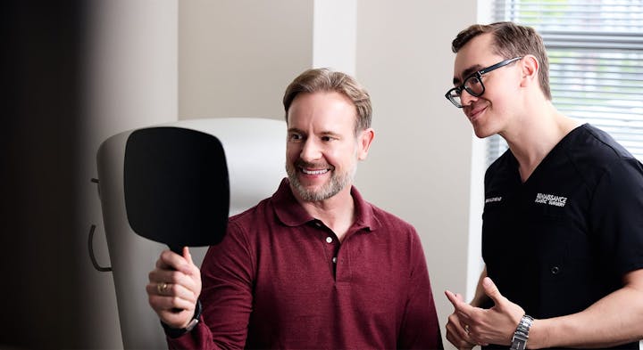 Dr. Alleyne with Male patient looking in mirror